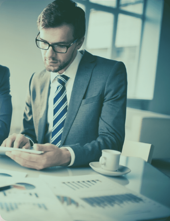 Businessman reviewing documents at a desk.