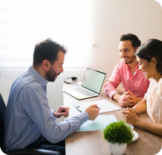 Man in blue shirt meets with couple.