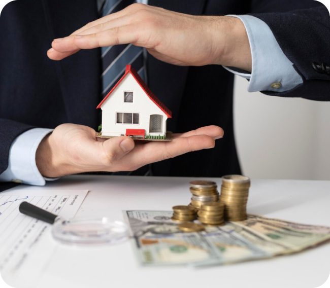 Man protecting a house model with money.