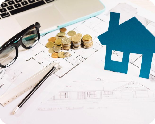 House plan with coins and a ruler.