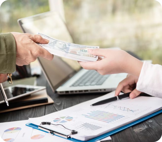 Hand passing money over a clipboard.