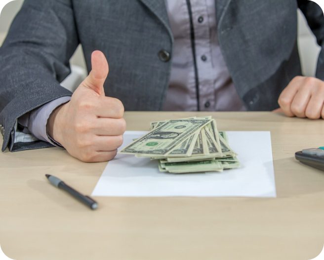 Businessman giving thumbs up with cash.